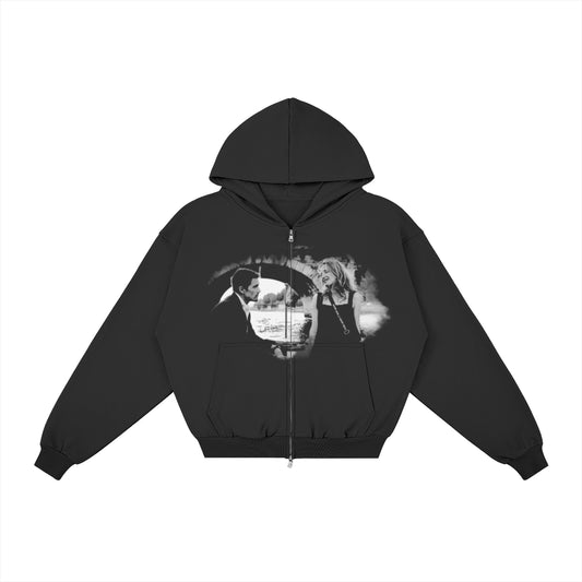 Before Sunset black zip hoodie, front view with faded black-and-white print of a couple under a stone bridge